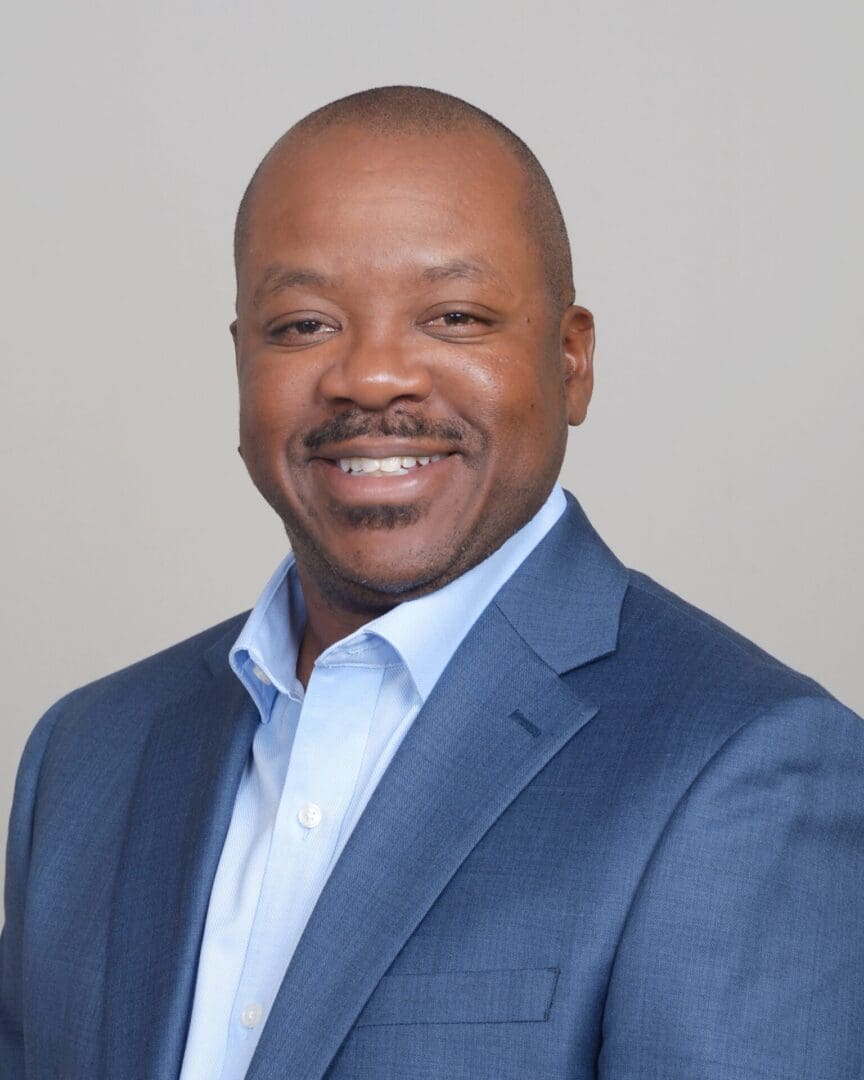 A man in a blue suit and white shirt